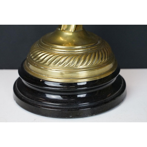 172 - Late Victorian / early 20th Century oil lamp raised on a round black pedestal base, brass twist desi... 