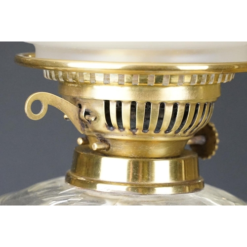 172 - Late Victorian / early 20th Century oil lamp raised on a round black pedestal base, brass twist desi... 