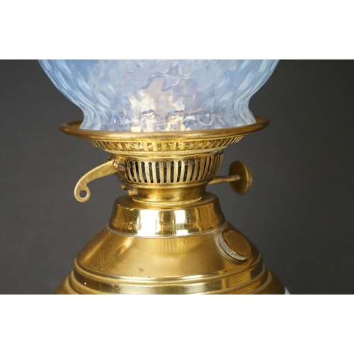 174 - Early 20th Century oil lamp having a round stepped brass base with blue ceramic reservoir and opalin... 