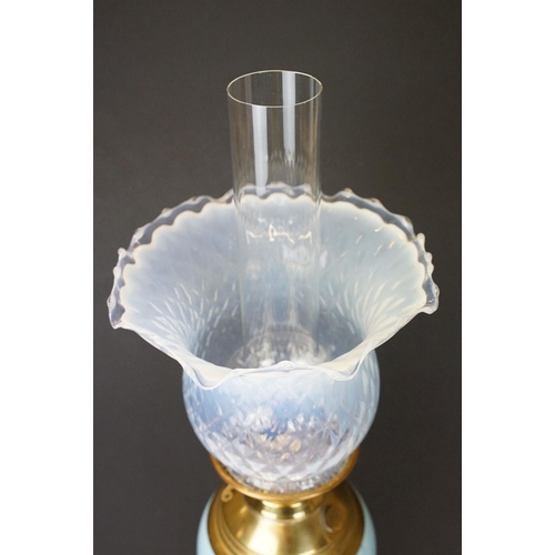 174 - Early 20th Century oil lamp having a round stepped brass base with blue ceramic reservoir and opalin... 