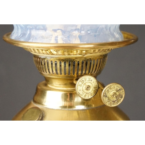 174 - Early 20th Century oil lamp having a round stepped brass base with blue ceramic reservoir and opalin... 