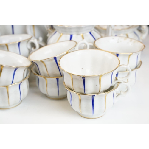 25 - Early 20th Century Furstenberg porcelain tea set of scalloped form, decorated with blue & gilt strip... 