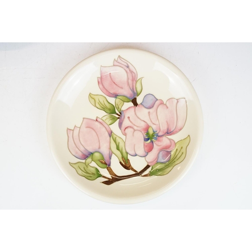 78 - Four Moorcroft pottery plates, to include an early-to-mid 20th C Hibiscus pattern plate on green gro... 