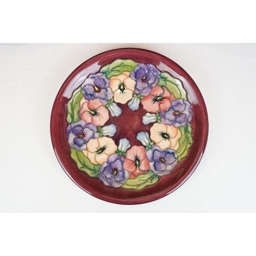 78 - Four Moorcroft pottery plates, to include an early-to-mid 20th C Hibiscus pattern plate on green gro... 