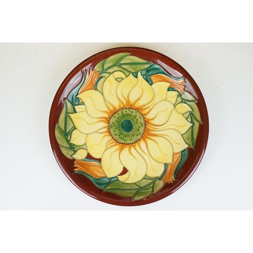 78 - Four Moorcroft pottery plates, to include an early-to-mid 20th C Hibiscus pattern plate on green gro... 