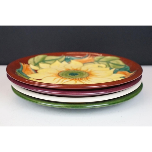 78 - Four Moorcroft pottery plates, to include an early-to-mid 20th C Hibiscus pattern plate on green gro... 