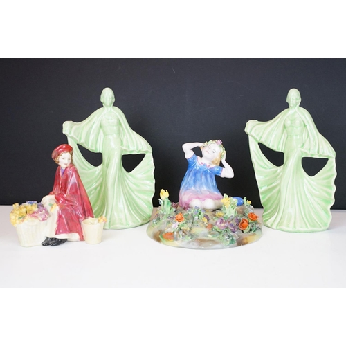 81 - Group of four ceramic figures to include a Crown Staffordshire floral encrusted figure of a girl sea... 