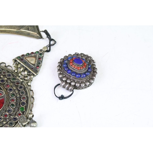 330A - Collection of middle eastern silver white metal pendants to include an Afghan coloured gem set penda... 