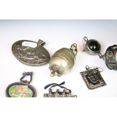 295A - A collection of mainly Indian white metal amulets including an example set with a large turquoise pa... 