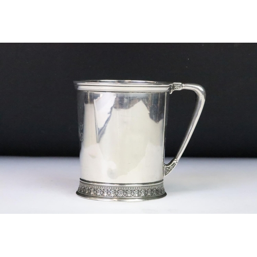 190 - A christening cup with single handle, ornate decoration to the foot, marked English Sterling to the ... 