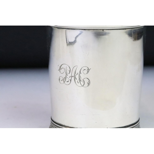 190 - A christening cup with single handle, ornate decoration to the foot, marked English Sterling to the ... 