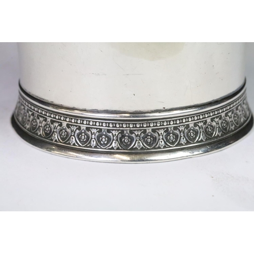 190 - A christening cup with single handle, ornate decoration to the foot, marked English Sterling to the ... 