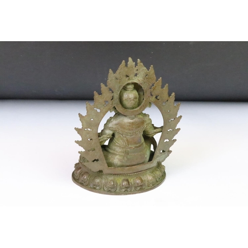 198 - A Chinese cast bronze ornamental Buddha statue, measures approx 12.5cm in height x 8.4cm in width.