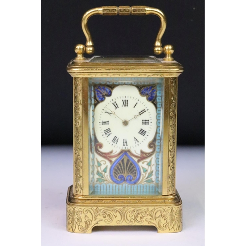 200 - A French miniature carriage clock with decorative enamel panels and dial, brass cased with beveled g... 