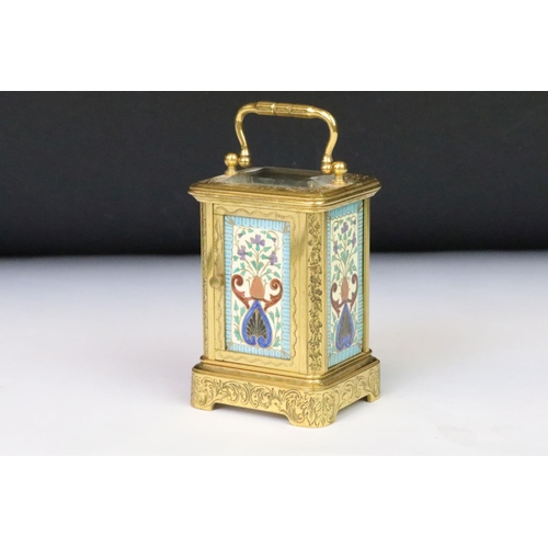 200 - A French miniature carriage clock with decorative enamel panels and dial, brass cased with beveled g... 