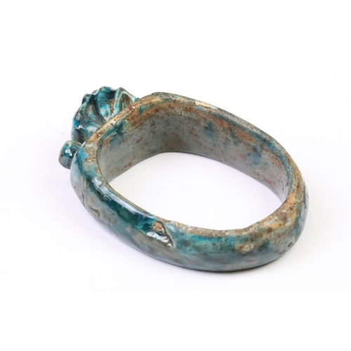 202 - An Egyptian faience bangle with green glaze and Ankh / key of life decoration to sides.