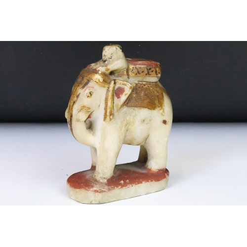 204 - A collection of four Indian carved stone hand painted figures, tallest approx 12.5cm