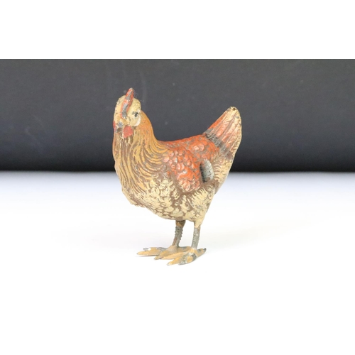 208 - A collection of three ornamental cold painted metal chicken figures.