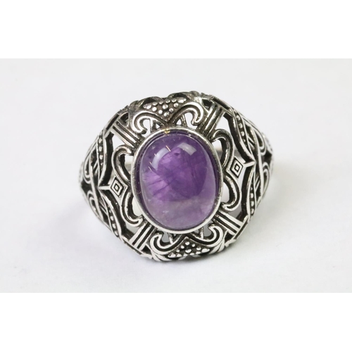 239 - A 925 Sterling silver with Amethyst cabochon ladies ring with pierced decoration to shoulders, marke... 