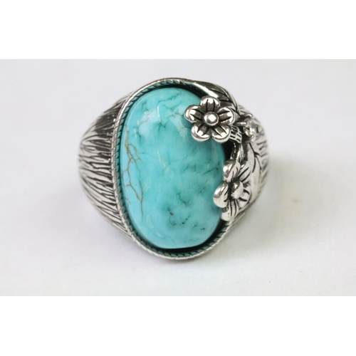 250 - A 925 Sterling silver with oval turquoise centre cabochon ladies ring with silver floral over spill,... 