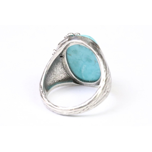 250 - A 925 Sterling silver with oval turquoise centre cabochon ladies ring with silver floral over spill,... 