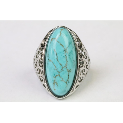 252 - A 925 Sterling silver with oval turquoise centre stone ladies ring with pieced decoration to shoulde... 