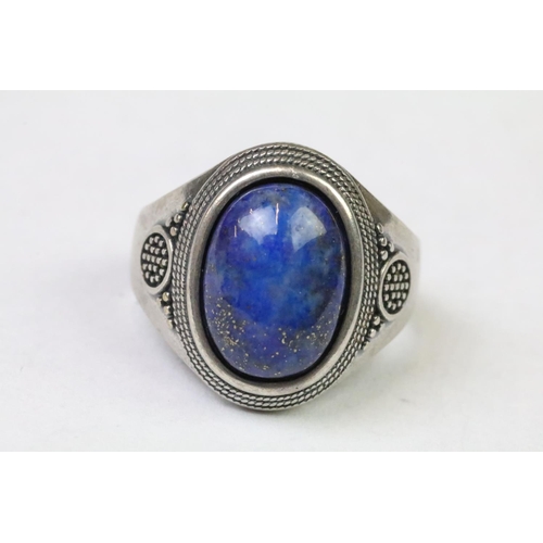 254 - A 925 Sterling silver with oval lapis lazuli centre cabochon ladies ring with decorative work to sho... 