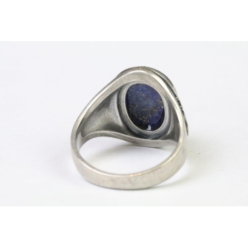 254 - A 925 Sterling silver with oval lapis lazuli centre cabochon ladies ring with decorative work to sho... 