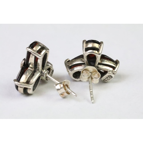 267 - A pair of sterling silver and garnet stud earrings.