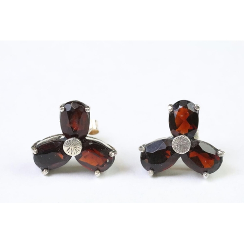 267 - A pair of sterling silver and garnet stud earrings.