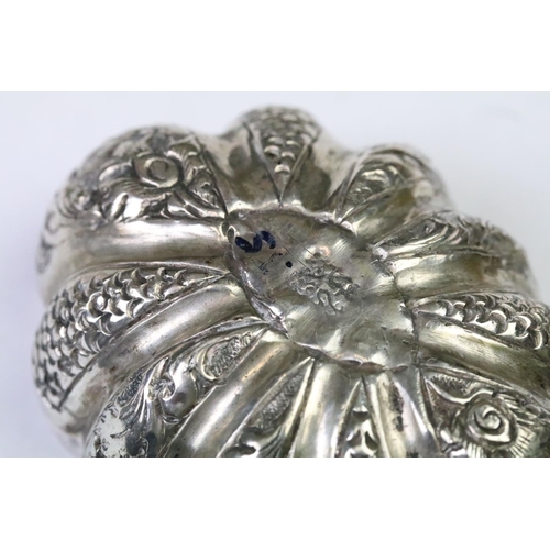 279 - A white metal (Tests Silver) Cambodian Pumpkin shaped betel nut holder, Repousse  decoration with fi... 