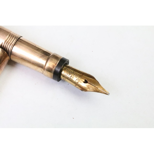 286 - A fully hallmarked 9ct rose gold fountain pen with 14ct gold nib, with inscription to side.