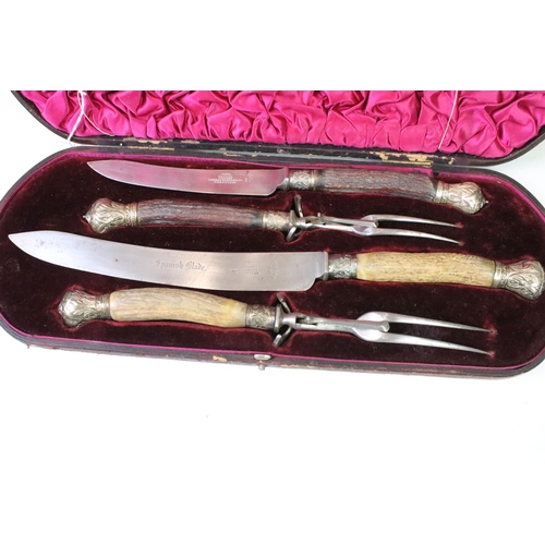 177 - A late 19th century cased carving set, antler handles with hallmarked silver mounts, dated 1896.