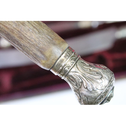 177 - A late 19th century cased carving set, antler handles with hallmarked silver mounts, dated 1896.