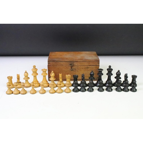 179 - A set of early 20th century boxwood chess pieces within wooden box.