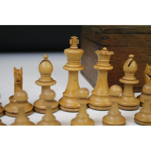 179 - A set of early 20th century boxwood chess pieces within wooden box.