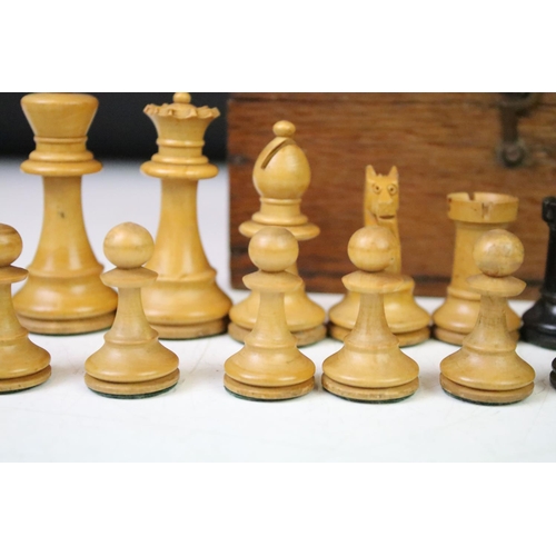 179 - A set of early 20th century boxwood chess pieces within wooden box.