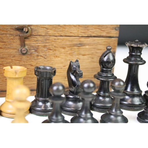 179 - A set of early 20th century boxwood chess pieces within wooden box.