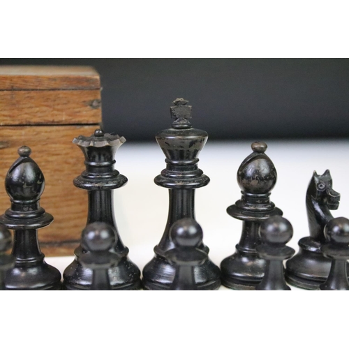 179 - A set of early 20th century boxwood chess pieces within wooden box.