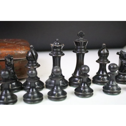 180 - A set of early 20th century boxwood chess pieces within a Huntley & Palmers biscuit tin.