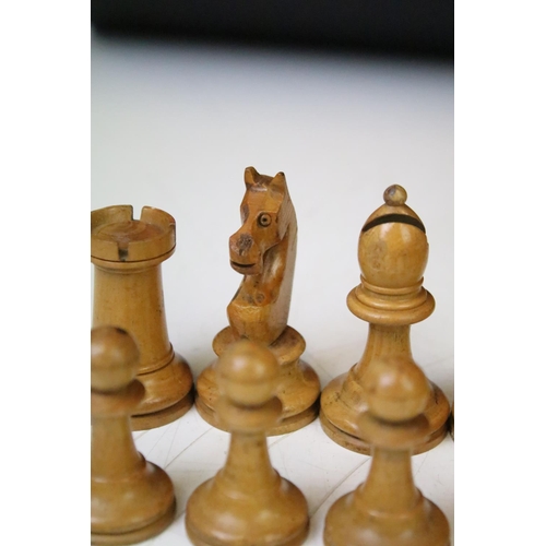 181 - A set of early 20th century boxwood chess pieces within wooden box.