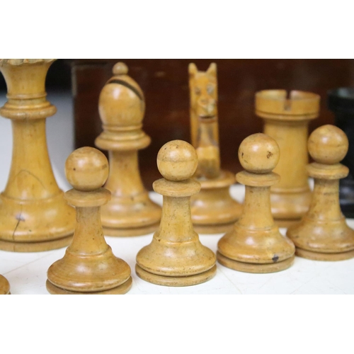 181 - A set of early 20th century boxwood chess pieces within wooden box.