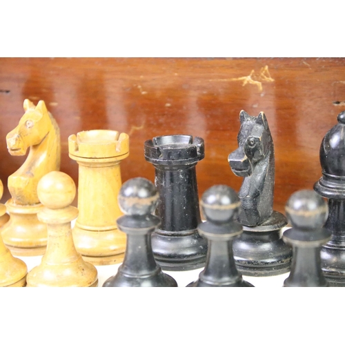 181 - A set of early 20th century boxwood chess pieces within wooden box.