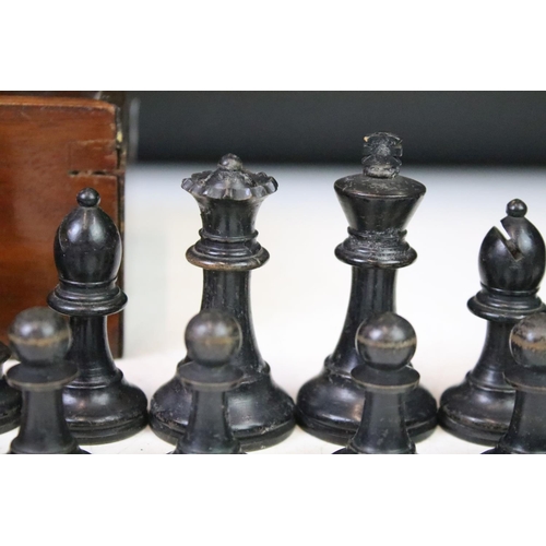 181 - A set of early 20th century boxwood chess pieces within wooden box.