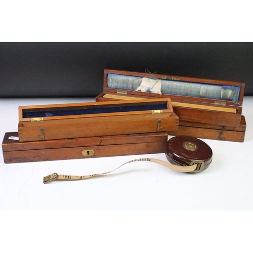 184 - A collection of early to mid 20th century boxwood rulers together with wooden storage boxes to inclu... 