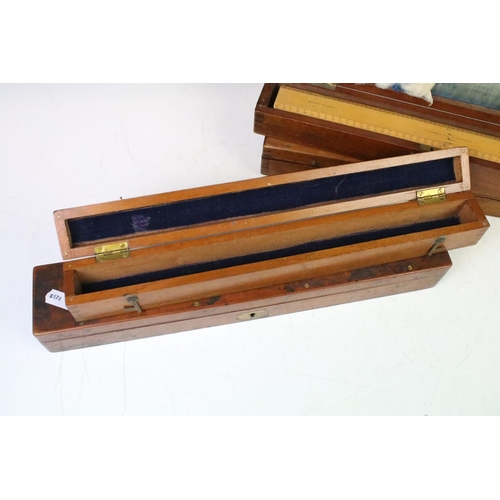 184 - A collection of early to mid 20th century boxwood rulers together with wooden storage boxes to inclu... 