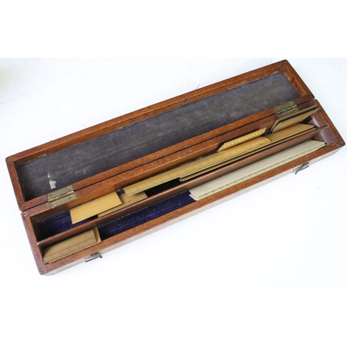 184 - A collection of early to mid 20th century boxwood rulers together with wooden storage boxes to inclu... 