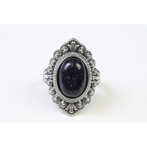 224 - A 925 Sterling silver with blue sandstone centre cabochon ladies ring with decorative surround, mark... 