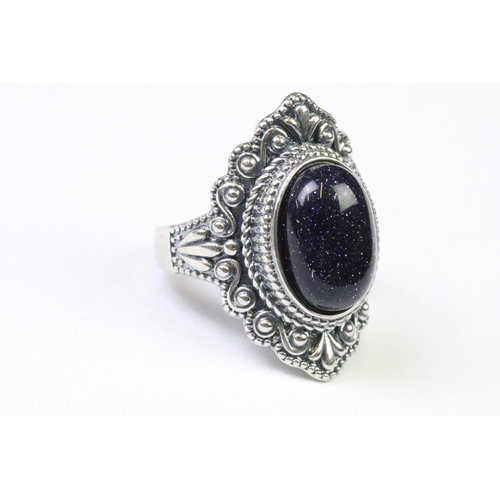 224 - A 925 Sterling silver with blue sandstone centre cabochon ladies ring with decorative surround, mark... 