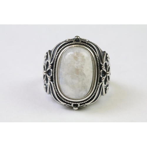 225 - A 925 Sterling silver with moonstone cabochon to centre ladies ring with decorative floral shoulders... 